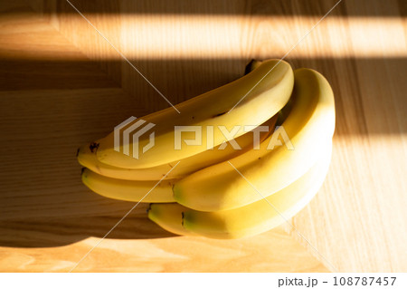 Bunch of bananas lying on the wooden background 108787457