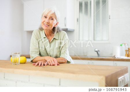 Portrait of cheerful old woman in kitchen 108791943