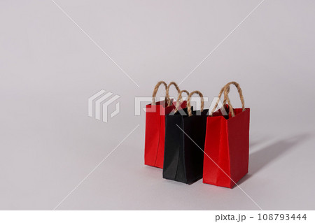 Black friday sale event design creative concept, red and black shopping bags with shadows on gray background, copy space 108793444