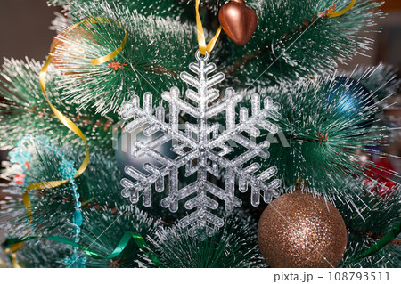 Christmas crystal snowflake on Christmas tree with blue Ribbon 108793511