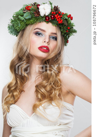Elegant blonde woman portrait. Fashion female model with blond curly hairstyle, make-up and green Elegant blonde woman portrait. Fashion female model with blond curly hairstyle, make-up and green 108796672
