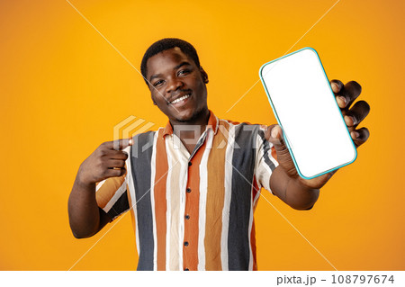Young african man showing smartphone with isolated screen copy space 108797674