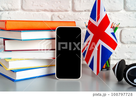 Headset and UK flag on working table 108797728