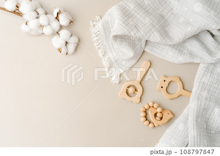 Baby muslin blanket and wooden toys for newborn 108797847