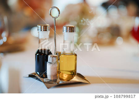 Set of containers for spices, oil and vinegar on a metal stand  108799817