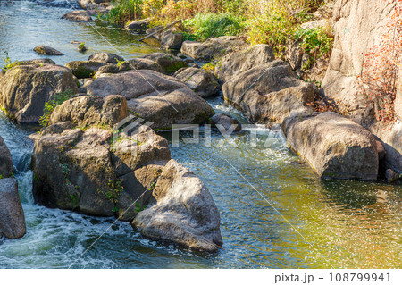 flow of water and spray from a stone 108799941