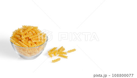 Pasta products in the form of a spiral on a plate, texture, on a white background 108800077