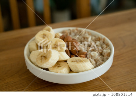 Oatmeal with banana, honey and almonda for breakfast on a table Oatmeal with banana, honey and almonda for breakfast on a table 108801514