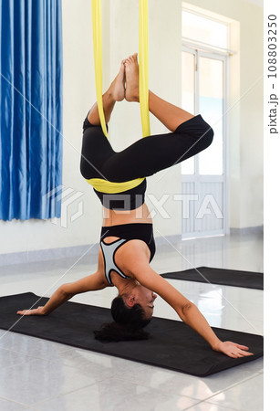 Young woman making aerial or fly yoga pose 108803250