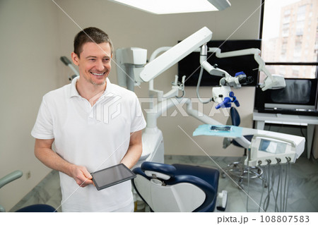 Dentist with digital tablet in dental office 108807583