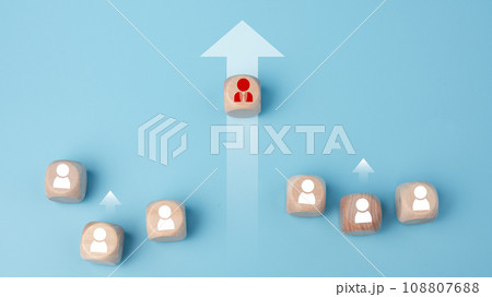 Leadership, business success, unique ideas, individuality, challenge, and motivation. Manager wooden block leads with rising arrow and followed by wooden block on blue background. 108807688
