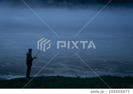 Man fishing on the mountain river at evening 108808075