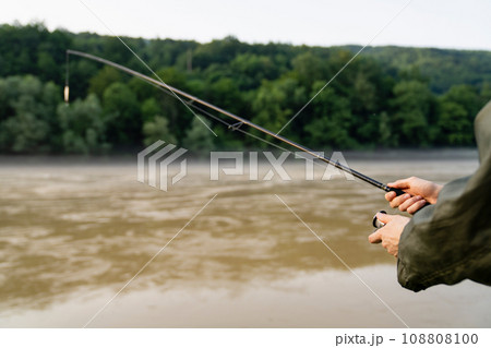Close-up of hands with a fishing rod 108808100