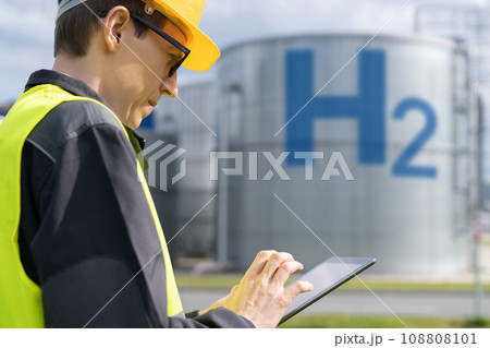 engineer with tablet computer on a background of Hydrogen factory 108808101