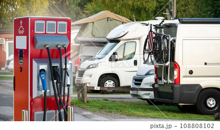 Close-up of a charging station for electric car against the backdrop of a campsite. 108808102