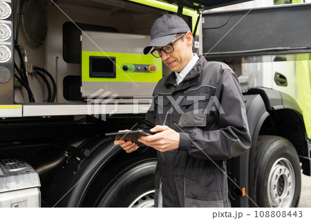 Worker with digital tablet operating construction machine equipment Worker with digital tablet operating construction machine equipment 108808443