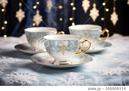 Winter themed tea party setup with snowflake patterned teacups and saucers. Generative AI 108809314