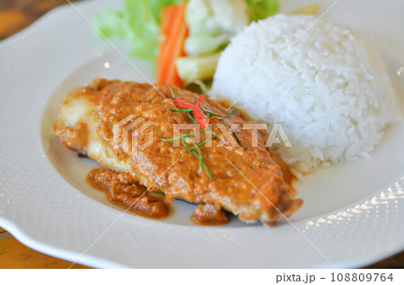 stir fried fish with chili ,sauce and rice or a king of curry cooked with fried fish served with a spicy sauce 108809764