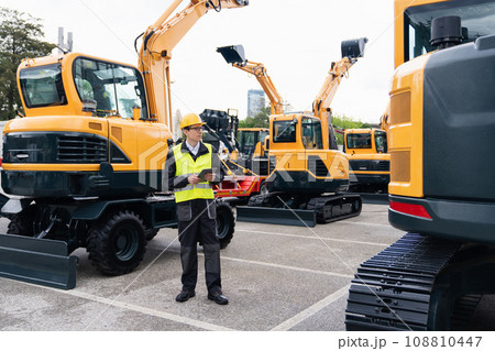 Engineer in a helmet with a digital tablet Engineer in a helmet with a digital tablet 108810447