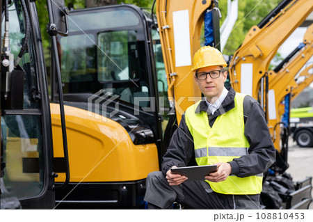 Engineer in a helmet with a digital tablet 108810453