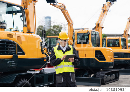 Engineer in a helmet with a digital tablet Engineer in a helmet with a digital tablet 108810934