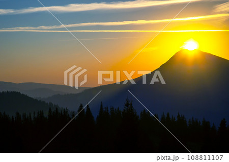 Morning sunrise over the top of a mountain in the Ukrainian Carpathians 108811107