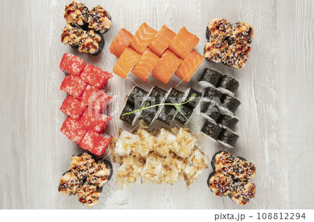 Set of various sushi rolls on a white wooden background. Japanese food. Set of various sushi rolls on a white wooden background. Japanese food. 108812294