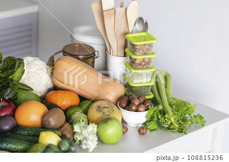 Set of fresh vegetables, fruits, nuts and grains on a white table in the kitchen, close-up, copy space, selective focus. Set of fresh vegetables, fruits, nuts and grains on a white table in the kitchen, close-up, copy space, selective focus. 108815236
