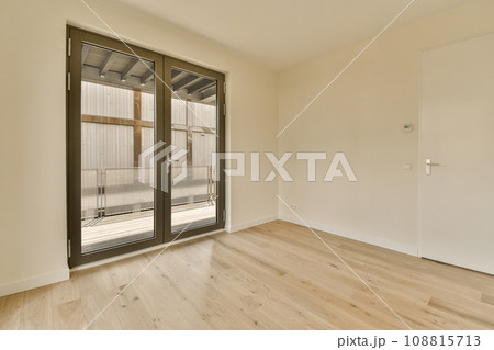 an empty room with wood floor and sliding glass door that leads to the patio area in the room is very clean 108815713