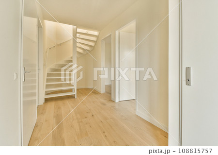 an empty room with wooden floors and white walls, there is a staircase leading up to the second floor in this photo 108815757