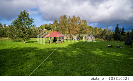 Wooden gazebo, resting place in the park. Equipped with wooden tables and benches 108816322