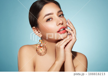 Portrait of beautiful young woman on blue background 108818213