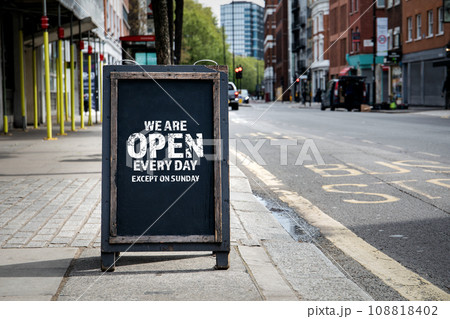 We are open every day except on Sunday. Foldable advertising poster on the street 108818402