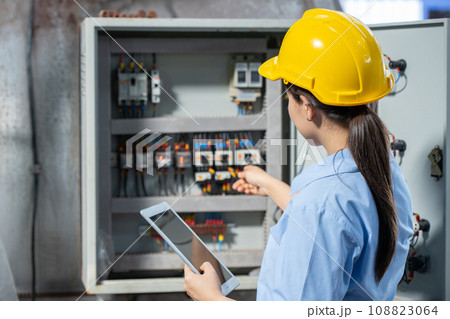 Electrician Engineer woman working check service maintenance electricity main circuit fuse and power system in industry factory 108823064