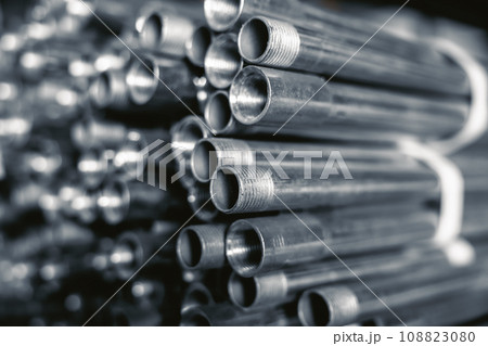 Metal pipes connector tubes. Construction cylindrical steel pipe stacked valious size in construction equipment store shelf. Metal pipes connector tubes. Construction cylindrical steel pipe stacked valious size in construction equipment store shelf. 108823080