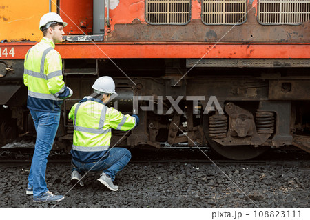 Locomotive repair worker, Train Engineer technician on duty working Maintenance Rolling Stocks of old diesel train passenger cabin in rail transport industry 108823111