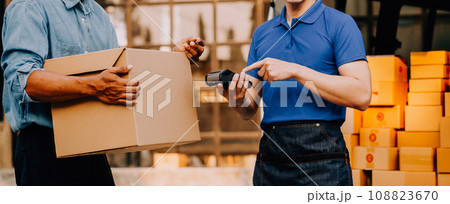 Asian delivery man in cargo van checking boxes. 108823670