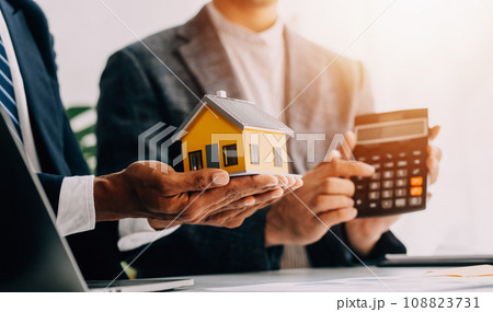Real estate agent and customer signing contract to buy house, insurance or loan real estate.rent a house,get insurance or loan real estate or property. Real estate agent and customer signing contract to buy house, insurance or loan real estate.rent a house,get insurance or loan real estate or property. 108823731