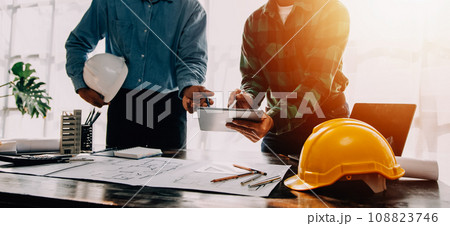 Construction and structure concept of engineer working drawing on blueprint meeting for project working with partner on model building and engineering tools in working site, construction concept. Construction and structure concept of engineer working drawing on blueprint meeting for project working with partner on model building and engineering tools in working site, construction concept. 108823746