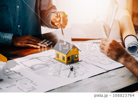 Construction and structure concept of engineer working drawing on blueprint meeting for project working with partner on model building and engineering tools in working site, construction concept. 108823764
