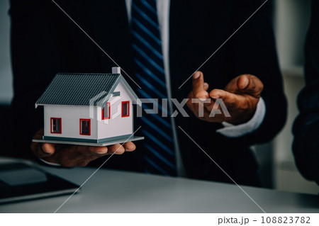 Real estate agent and customer signing contract to buy house, insurance or loan real estate.rent a house,get insurance or loan real estate or property. 108823782