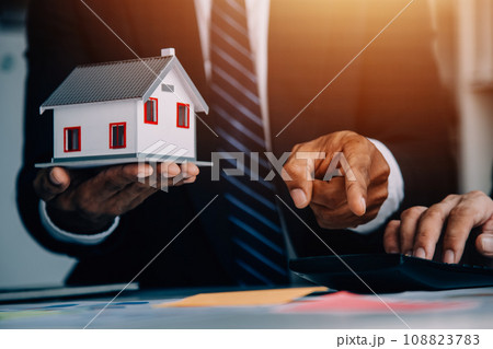 Real estate agent and customer signing contract to buy house, insurance or loan real estate.rent a house,get insurance or loan real estate or property. 108823783