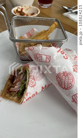 A portion of Sujuk Wrap Turkish food on the wooden table A portion of Sujuk Wrap Turkish food on the wooden table 108824215