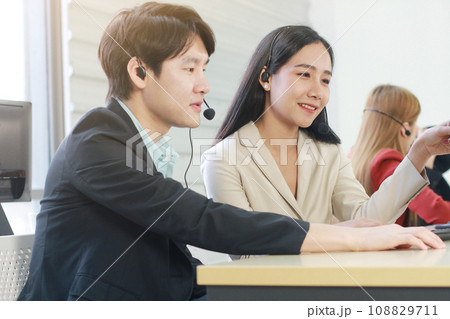 Business Call Center and technical Support staff or receptionist phone operator Discussing and working for teamwork with computer. Asian customer support team. Business Call Center and technical Support staff or receptionist phone operator Discussing and working for teamwork with computer. Asian customer support team. 108829711