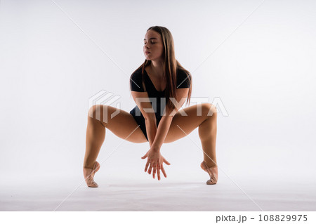 Ballet dancer in black body paint isolated on studio background expressive artistic dance concept Ballet dancer in black body paint isolated on studio background expressive artistic dance concept 108829975
