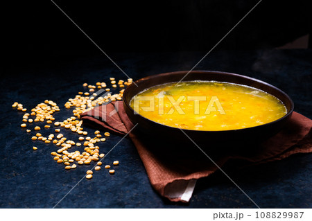 Appetizing hot pea soup and onion served with slices of bread Appetizing hot pea soup and onion served with slices of bread 108829987