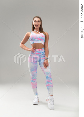 sexy athletic girl in a tight fitness tracksuit on a light background copy paste in the studio 108830082