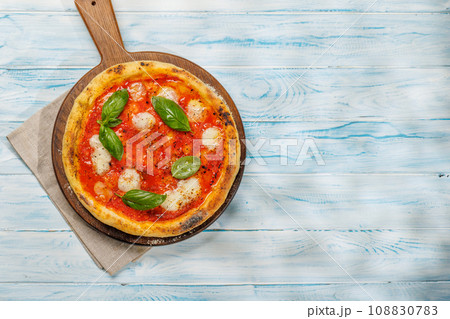 Margarita pizza with tomatoes, mozzarella cheese and basil Margarita pizza with tomatoes, mozzarella cheese and basil 108830783