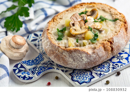 Homemade potato-mushroom soup in a loaf of bread. 108830932
