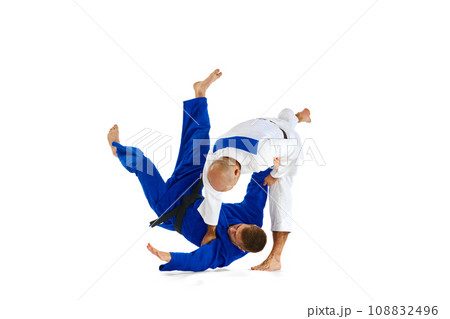 Two young man professional judoist fighting, performing technical skill isolated white studio background. Copy space for ad, text 108832496